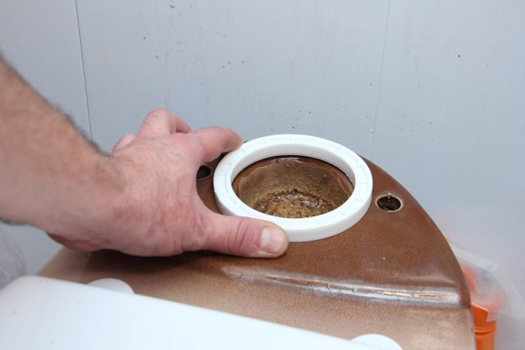 Plumber hand install new O-ring sealing on the old ceramic brown toilet
