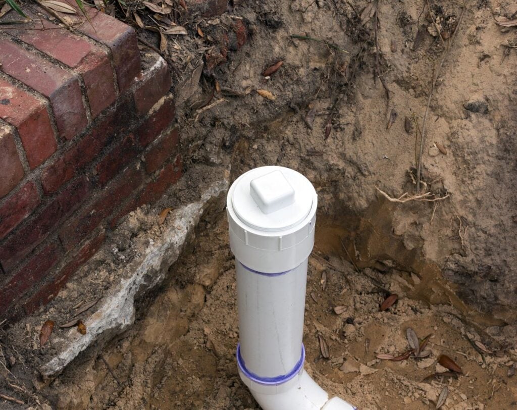 New PVC Sewer Pipe Line Installed in Trench