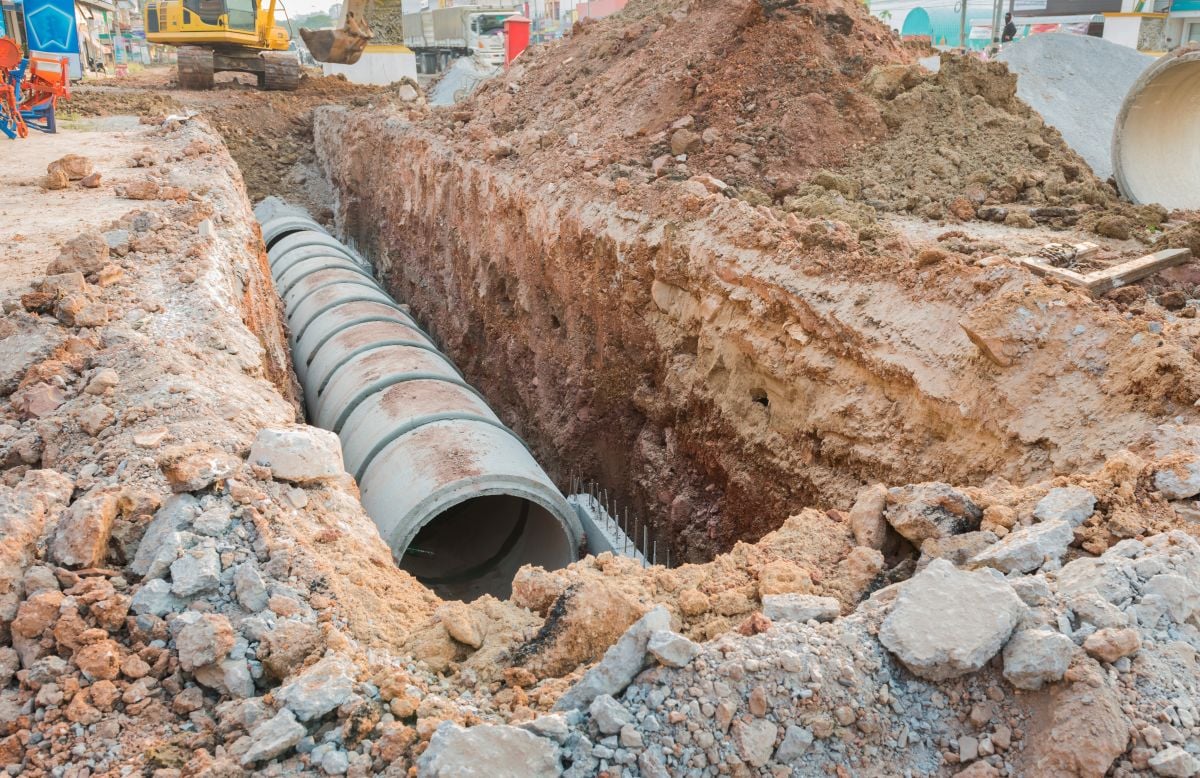 Concrete drainage tube row underground near construction site