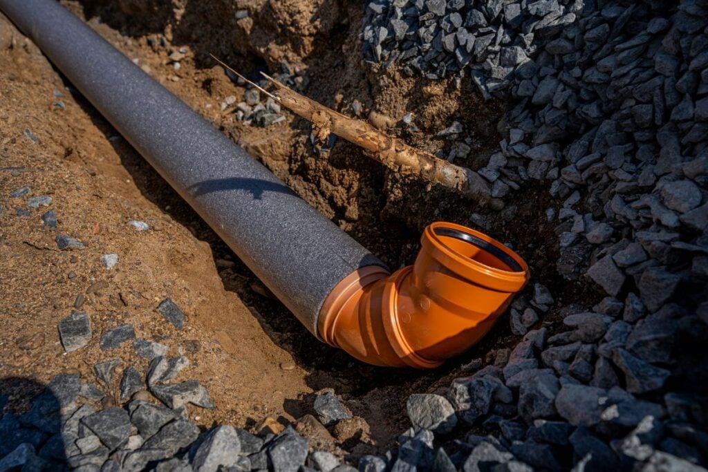 sewer pipe in thermal insulation, laid in a trench