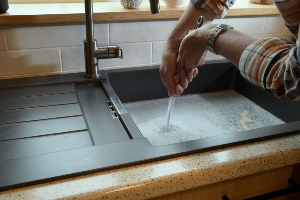 Overflowing kitchen sink, clogged drain