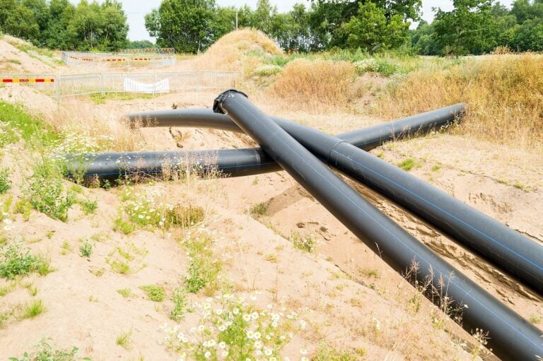 Plastic pipes being placed under ground
