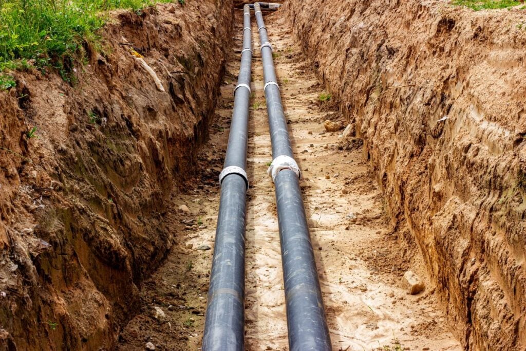 connecting pipes in the trench of ground