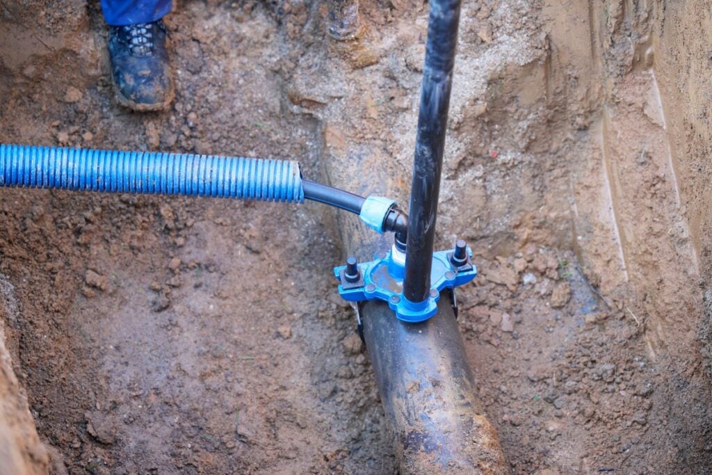 Construction worker, repairing a broken water pipe