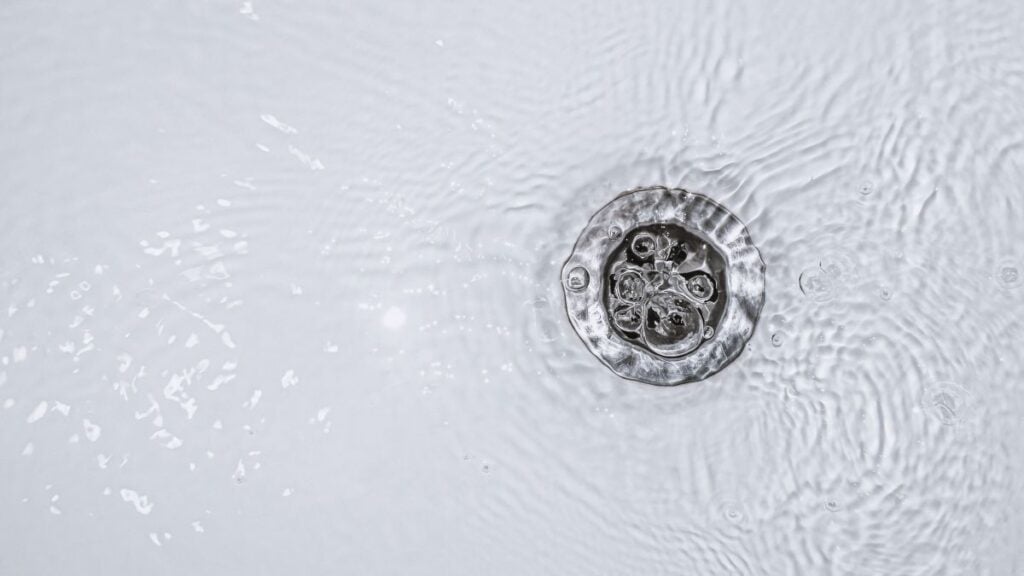 Slow water drain. Household plumbing problem. Water draining down slowly in tub