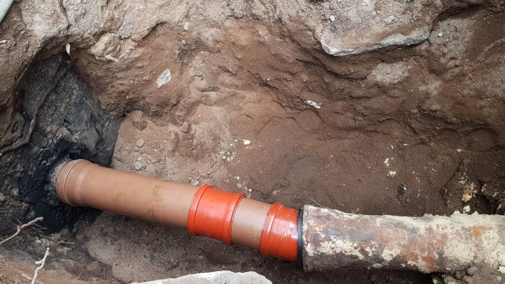 the sewer pipe burst. a dug hole for the repair of sewer pipes. care and maintenance in a private house.