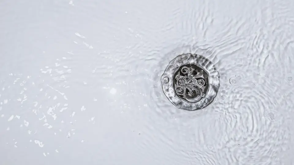 Slow water drain. Household plumbing problem. Water draining down slowly in tub. Bath cleaning